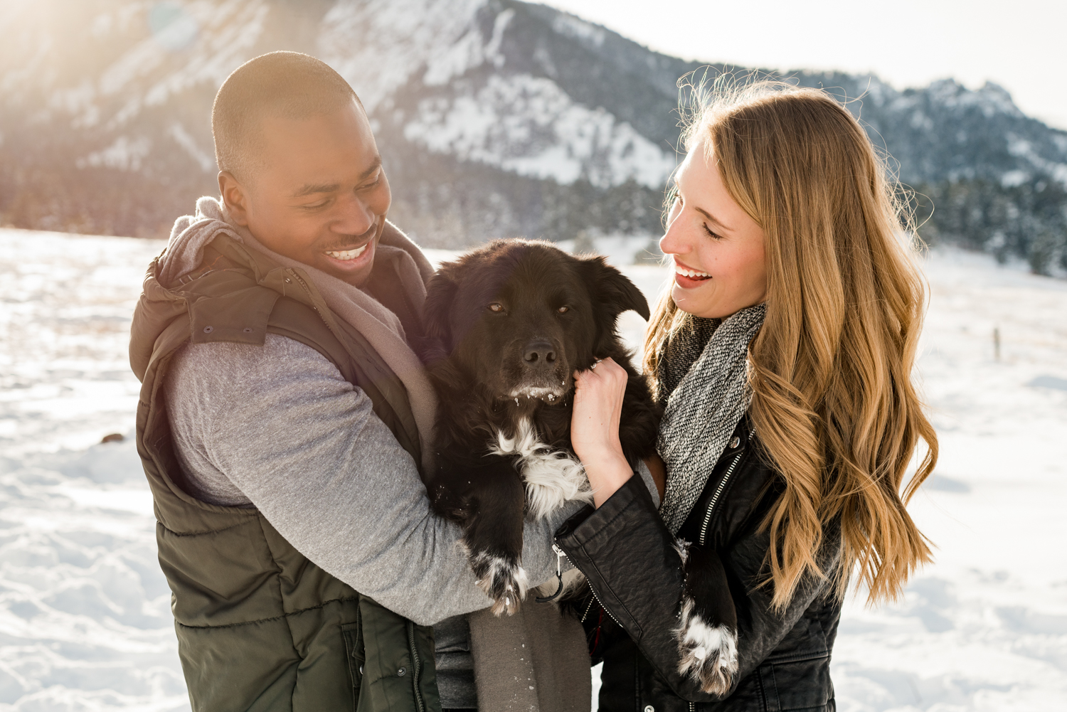 Couple holds dog for engagement photo | Pets In Human Photo Sessions