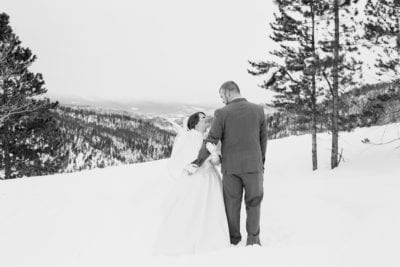 Bride and groom in snow black and white