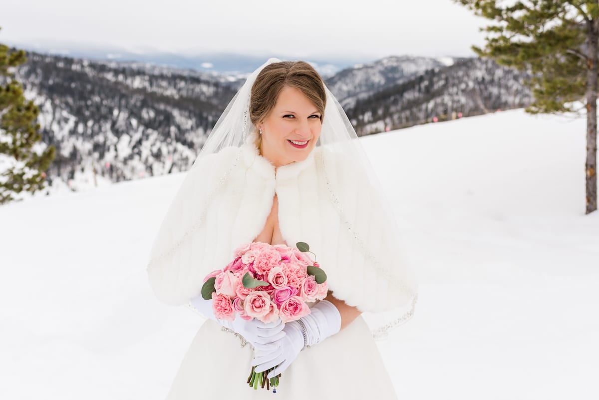 Bride with bouquet on snowy mountain