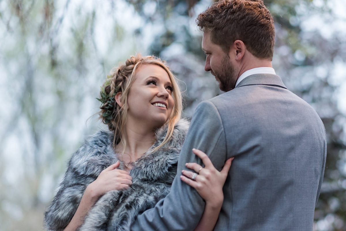keep warm during a winter wedding | Wedding Photography | From the Hip Photo | bride looks lovingly at groom in winter shawl