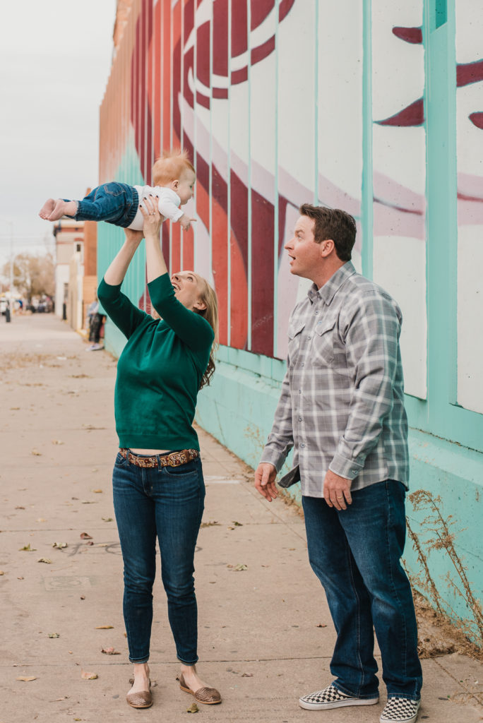 RiNo Art District mother plays with baby girl outdoors urban city art family photos