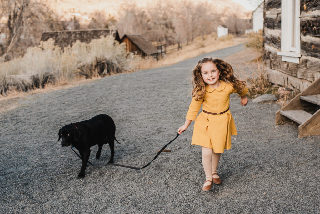 Little girl and small dog smiling child outdoors Golden Colorado