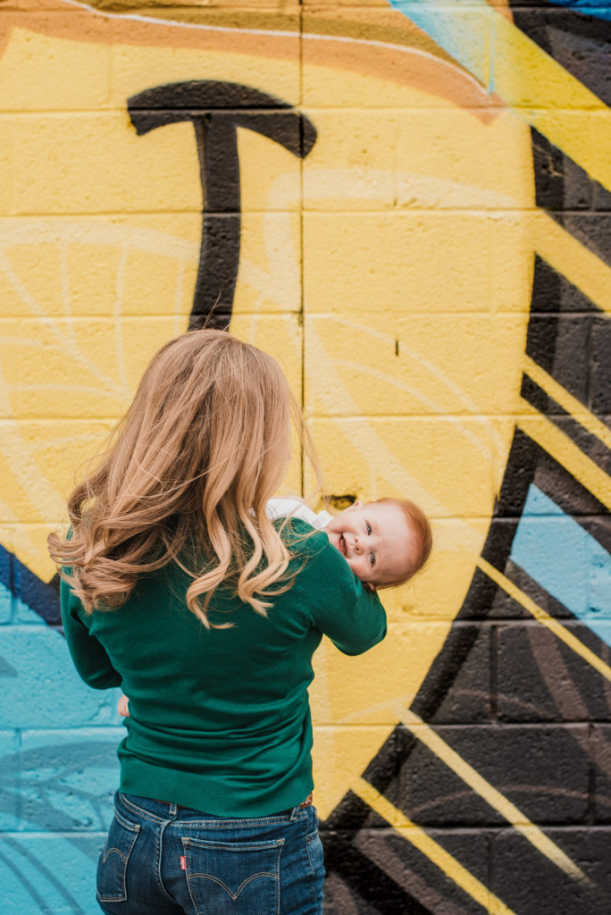 RiNo Art District colorful urban family photos mother and daughter smiling baby parent carrying daughter