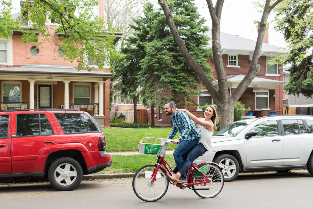 Expert tips to plan fun downtown Denver engagement photos riding bikes romantic engagement picture | From the Hip Photo Denver Colorado portrait photography 