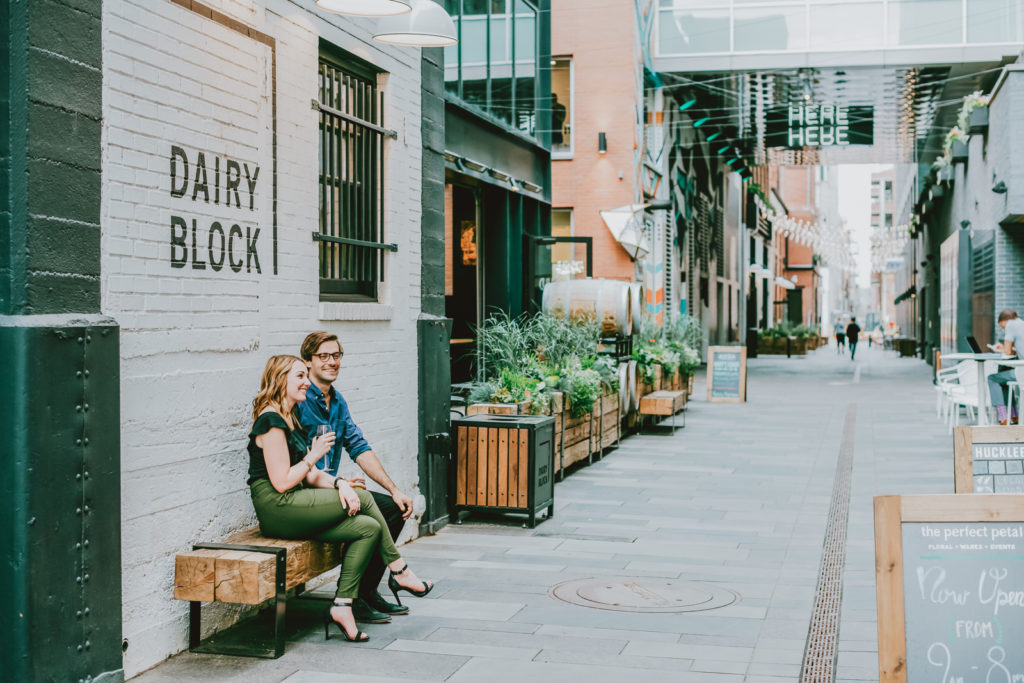 Downtown Denver Dairy Block outdoor urban fun candid loving engagement picture | From the Hip Photo Denver portrait photography 
