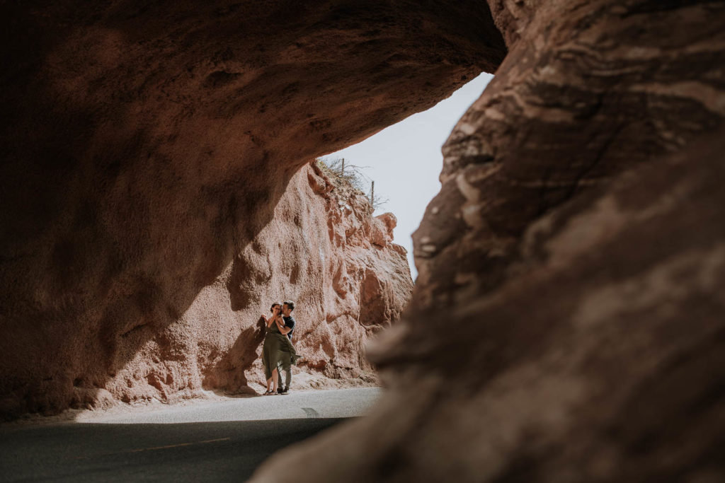 Red Rocks, Colorado | Outdoors | Couple embracing | Engagement photos