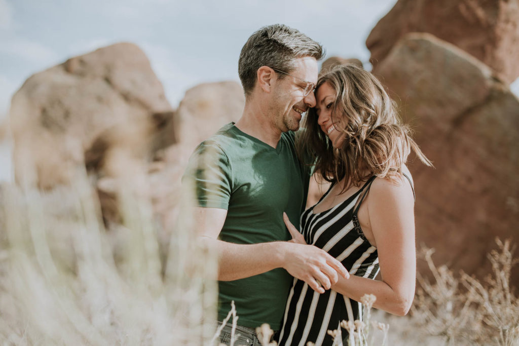 Red Rocks, Colorado | Outdoors | Couple embracing | Engagement photos