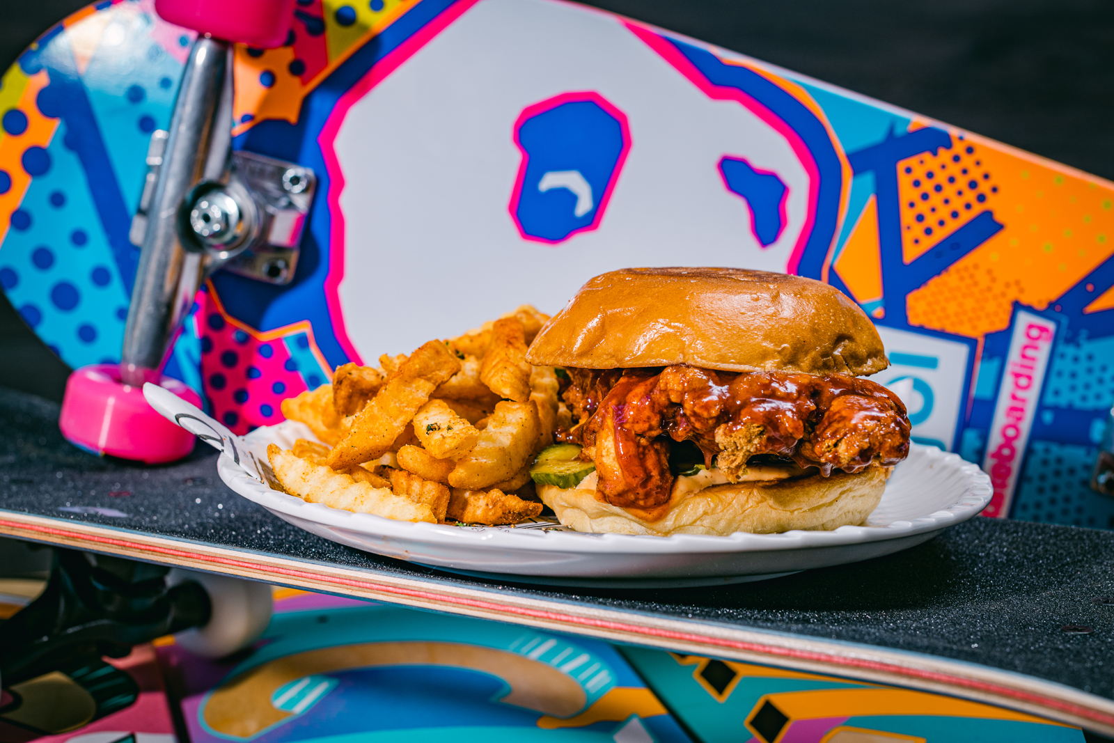 A plate and sandwich in front of a skateboard | Bethesda, MD | Oceanside, CA