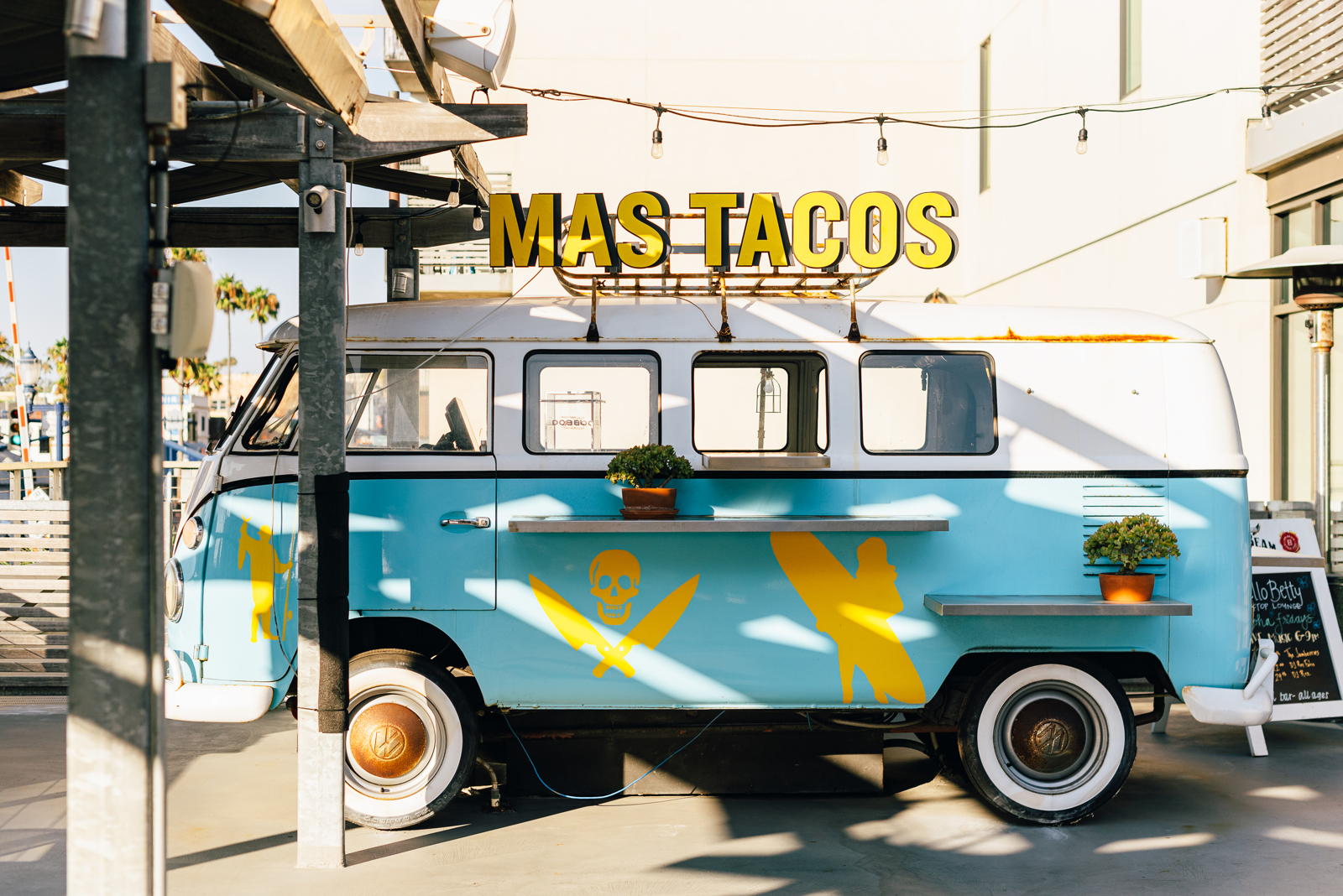 A blue and yellow van with a sign reading "Mas Tacos" atop it | Bethesda, MD | Oceanside, CA