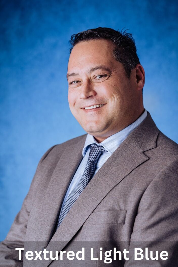 Professional portrait on Textured Light Blue backdrop — Denver studio photography by From the Hip Photo