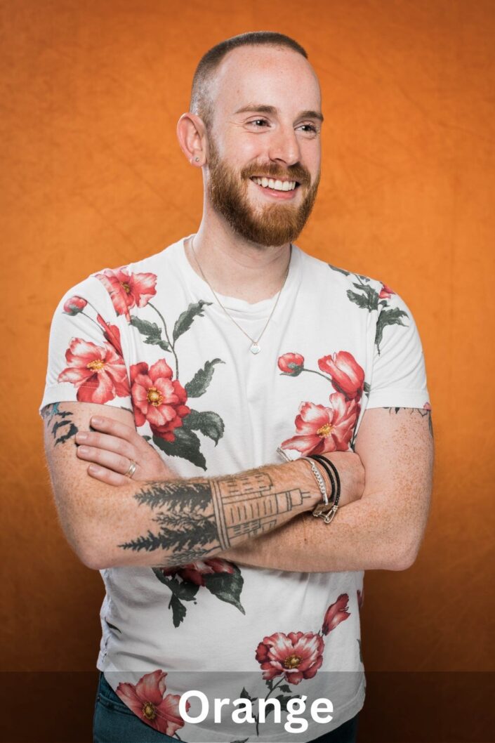 Professional portrait on Orange backdrop — Denver studio photography by From the Hip Photo