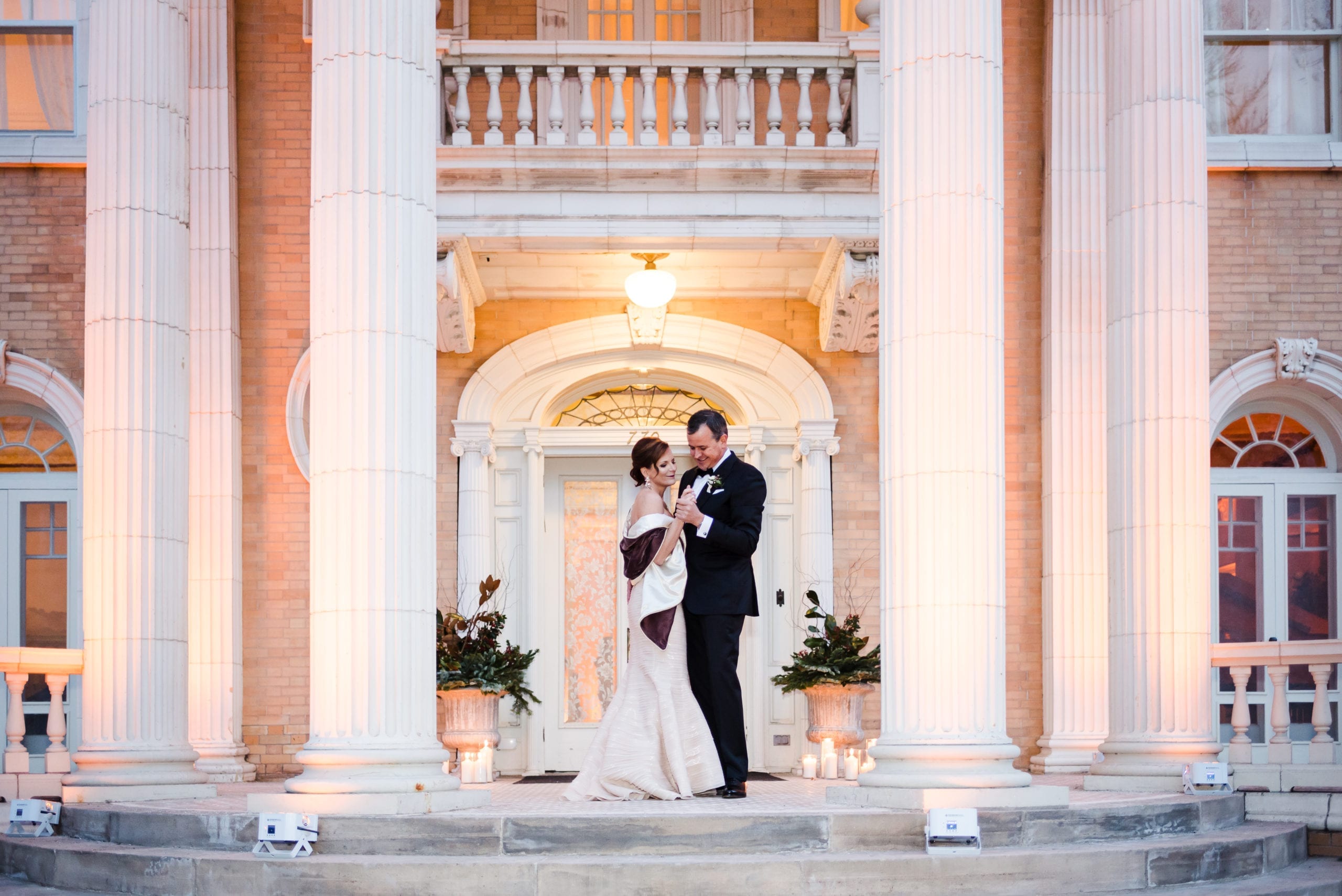Bride and groom on the grand staircase at Grant-Humphreys Mansion