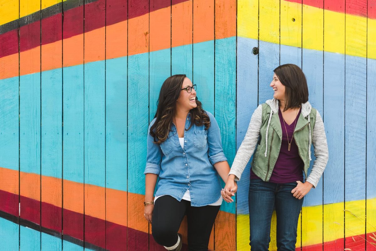 Engaged couple exploring urban Denver during engagement photo session with From the Hip Photo