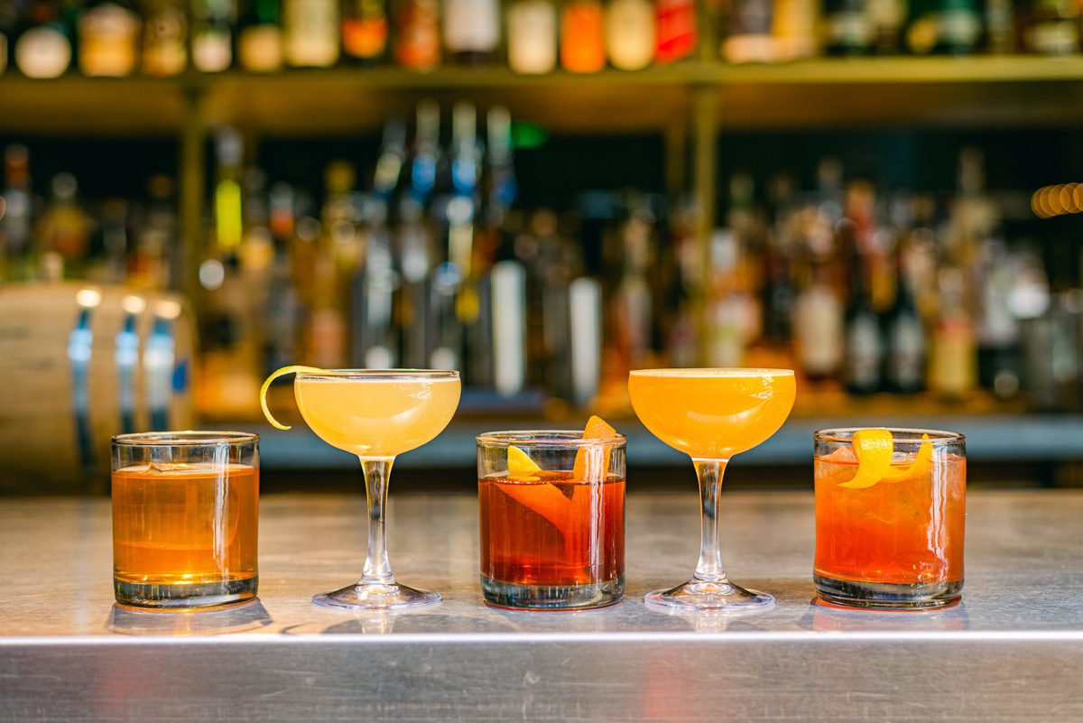 Five cocktails on steel bar