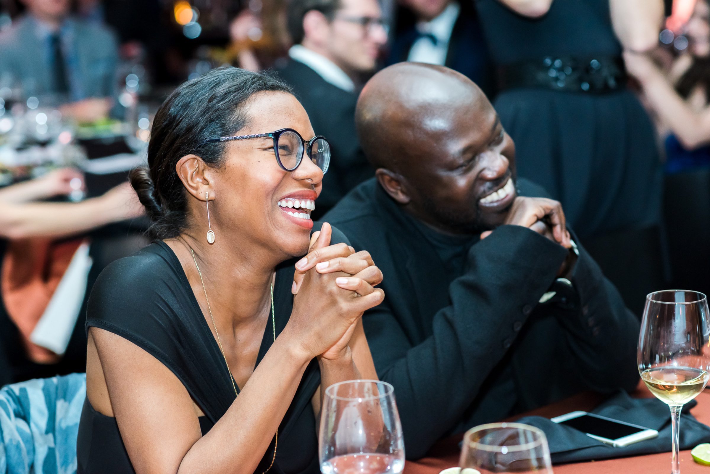 Gala dinner candid -- laughter at the table over wine