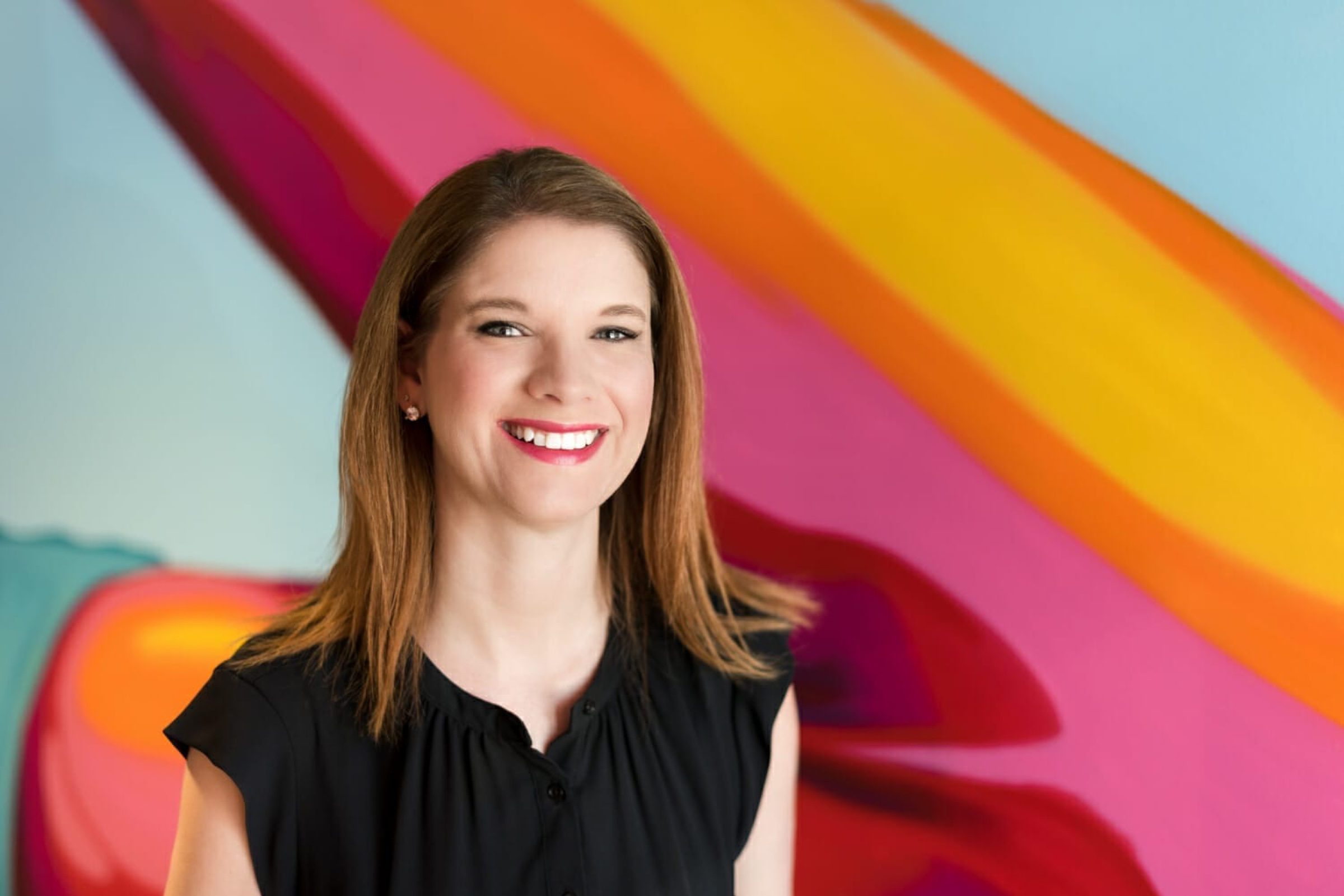 Painted-mural backdrop -- bold environmental color, considered eye contact