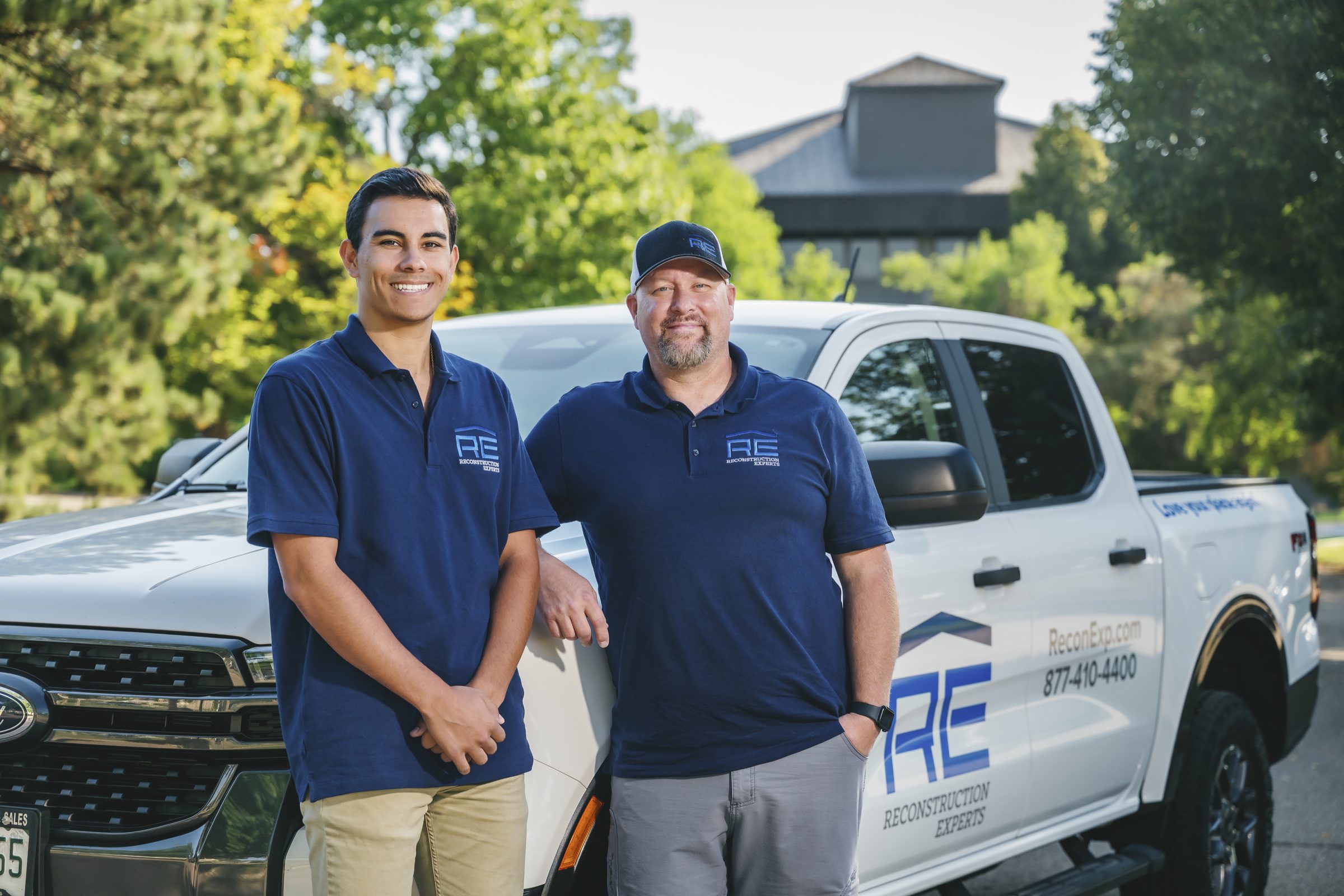 Team portrait with branded truck