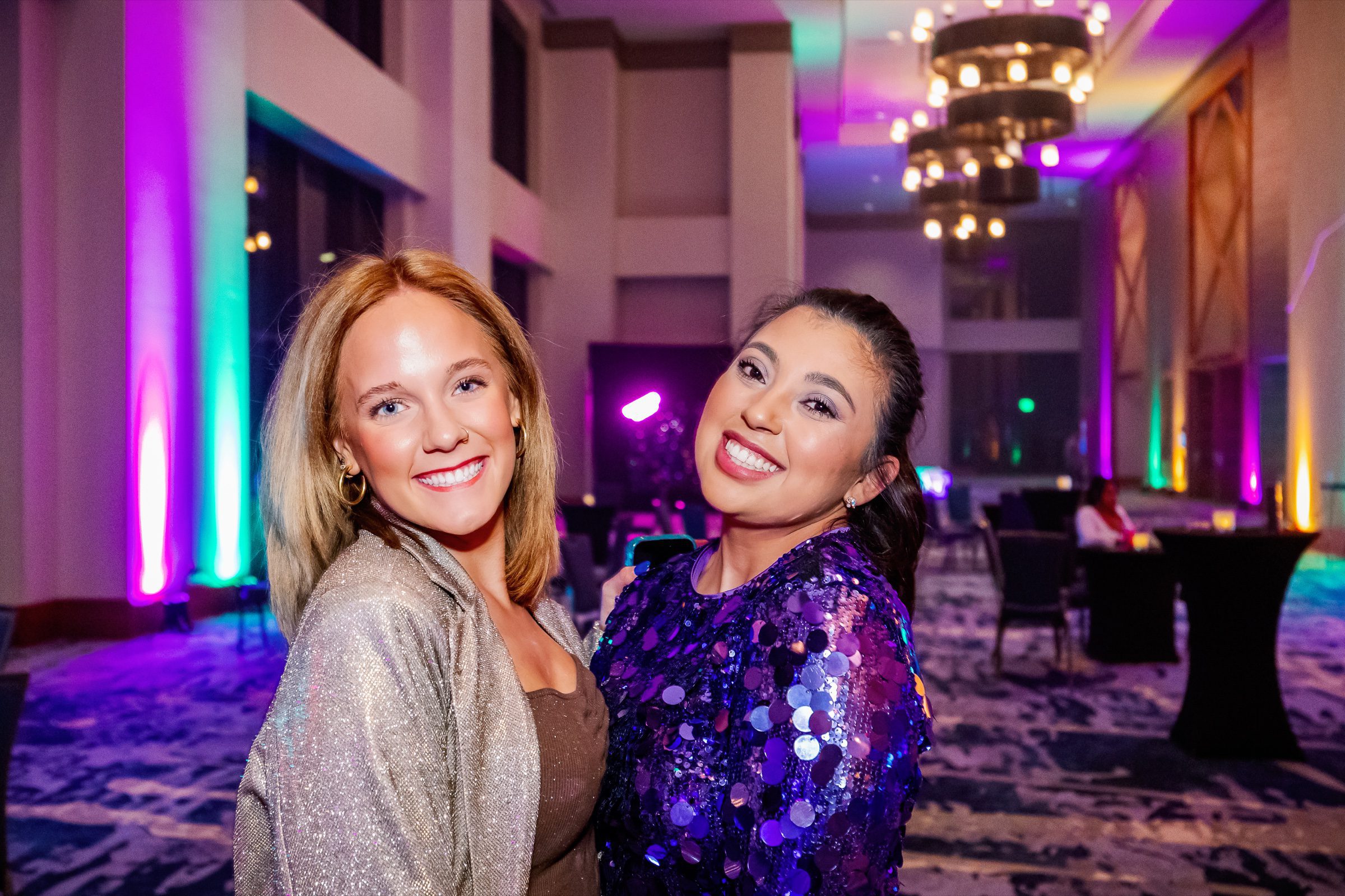 Reception candid -- gala lighting + warm guest moment