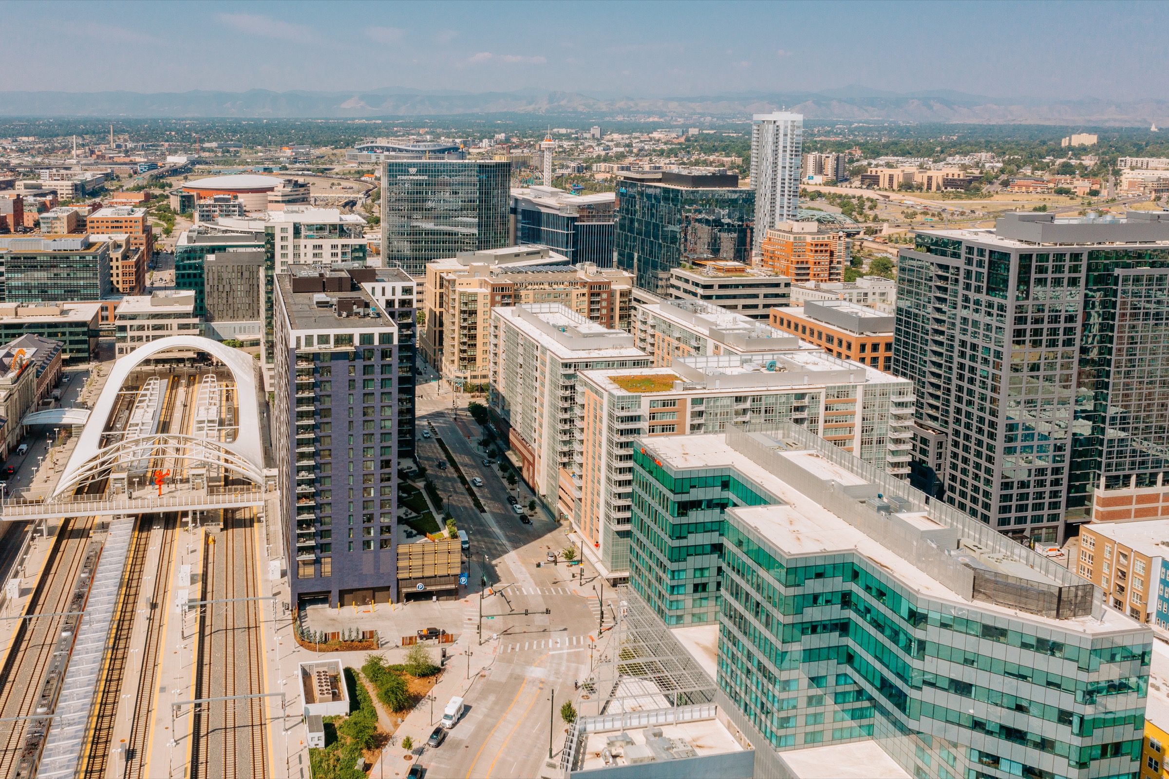 Aerial cityscape showing modern mixed-use buildings and transit infrastructure