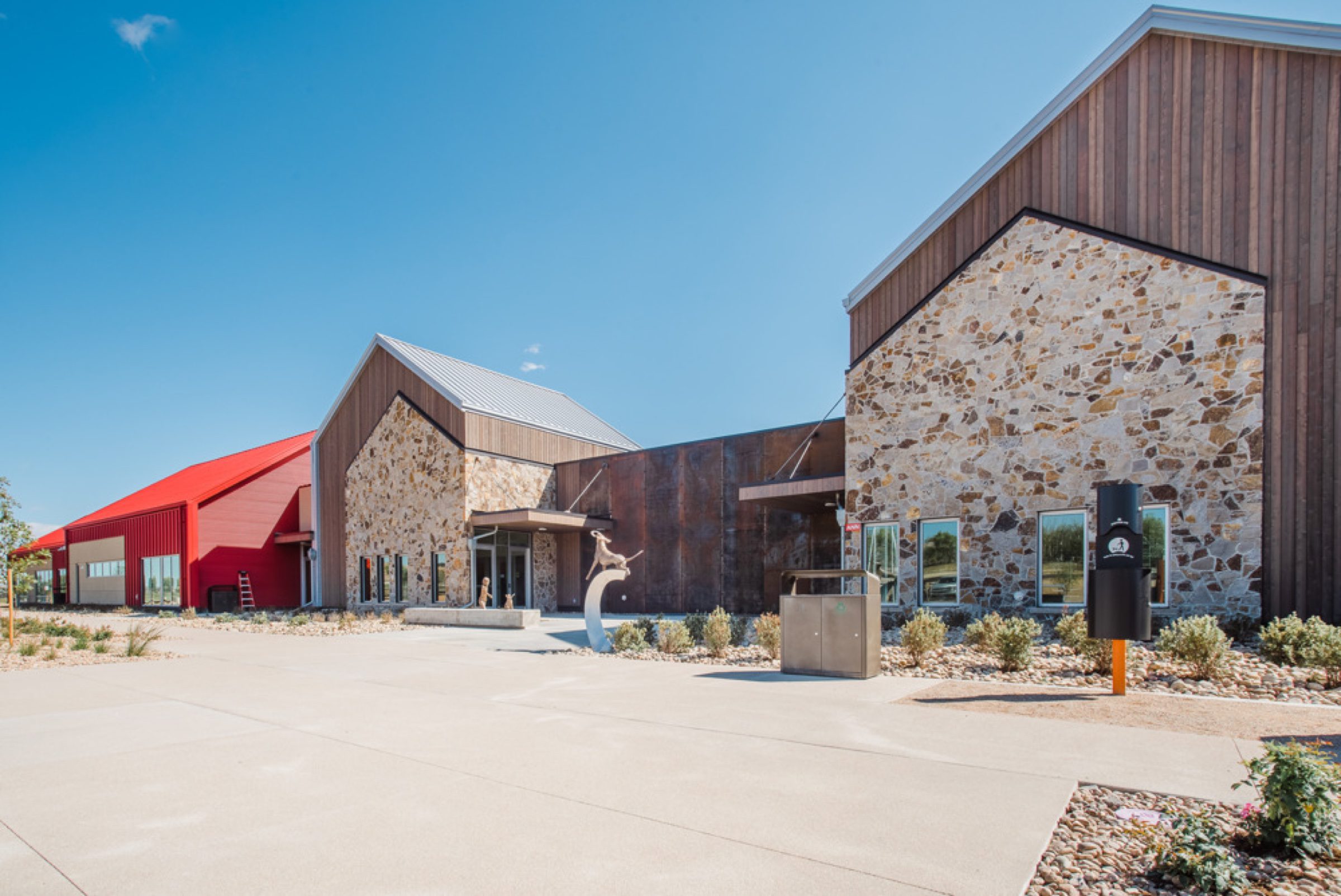 Animal-care facility entrance with warm wood, stone, and signature accent color
