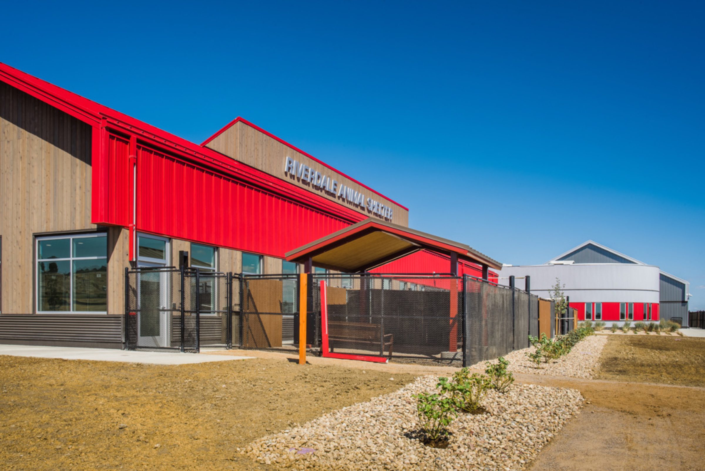 Exterior signage and outdoor pet-yard architecture in natural light