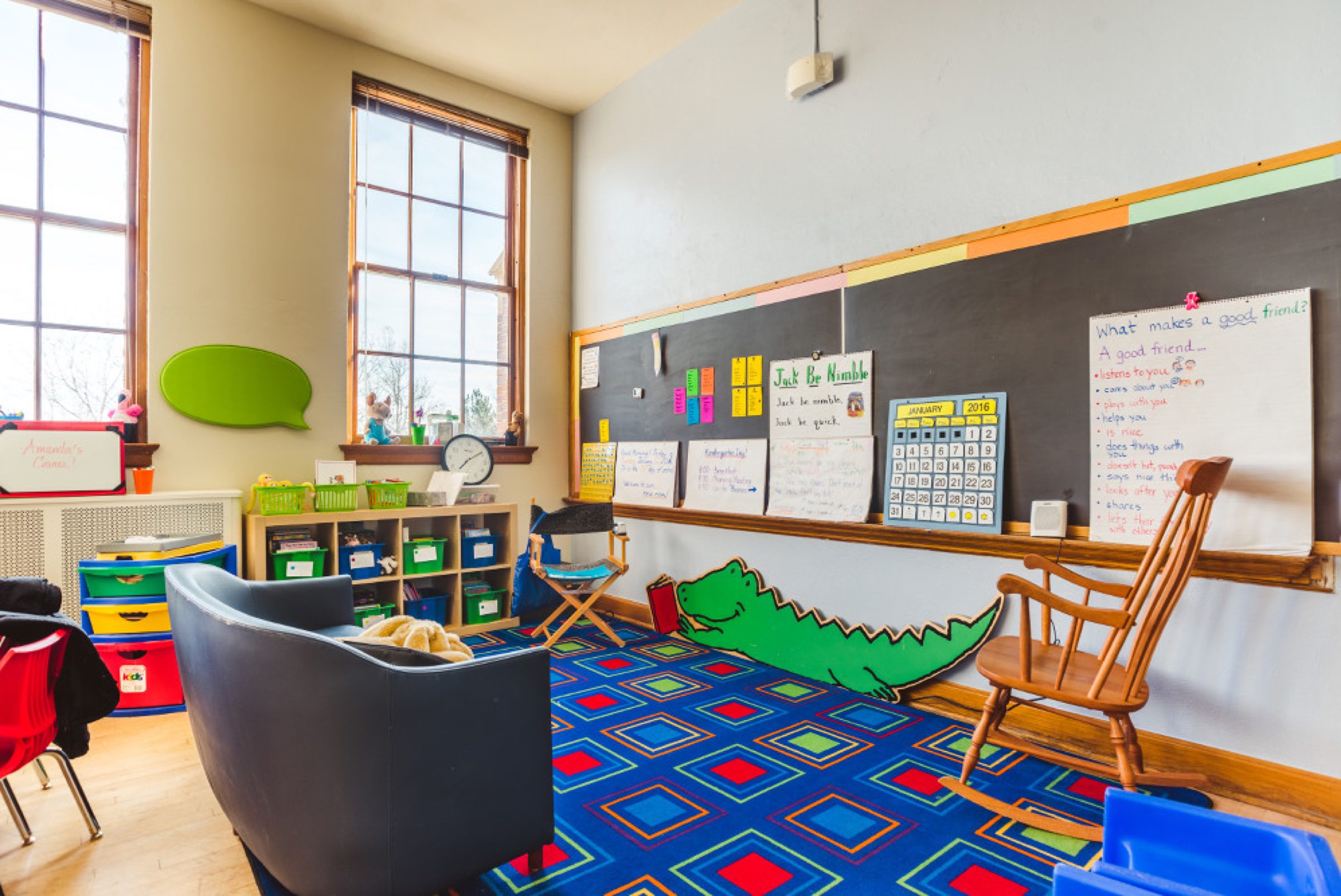 Classroom story corner -- chalkboard + alligator rug + kid-scale rocker