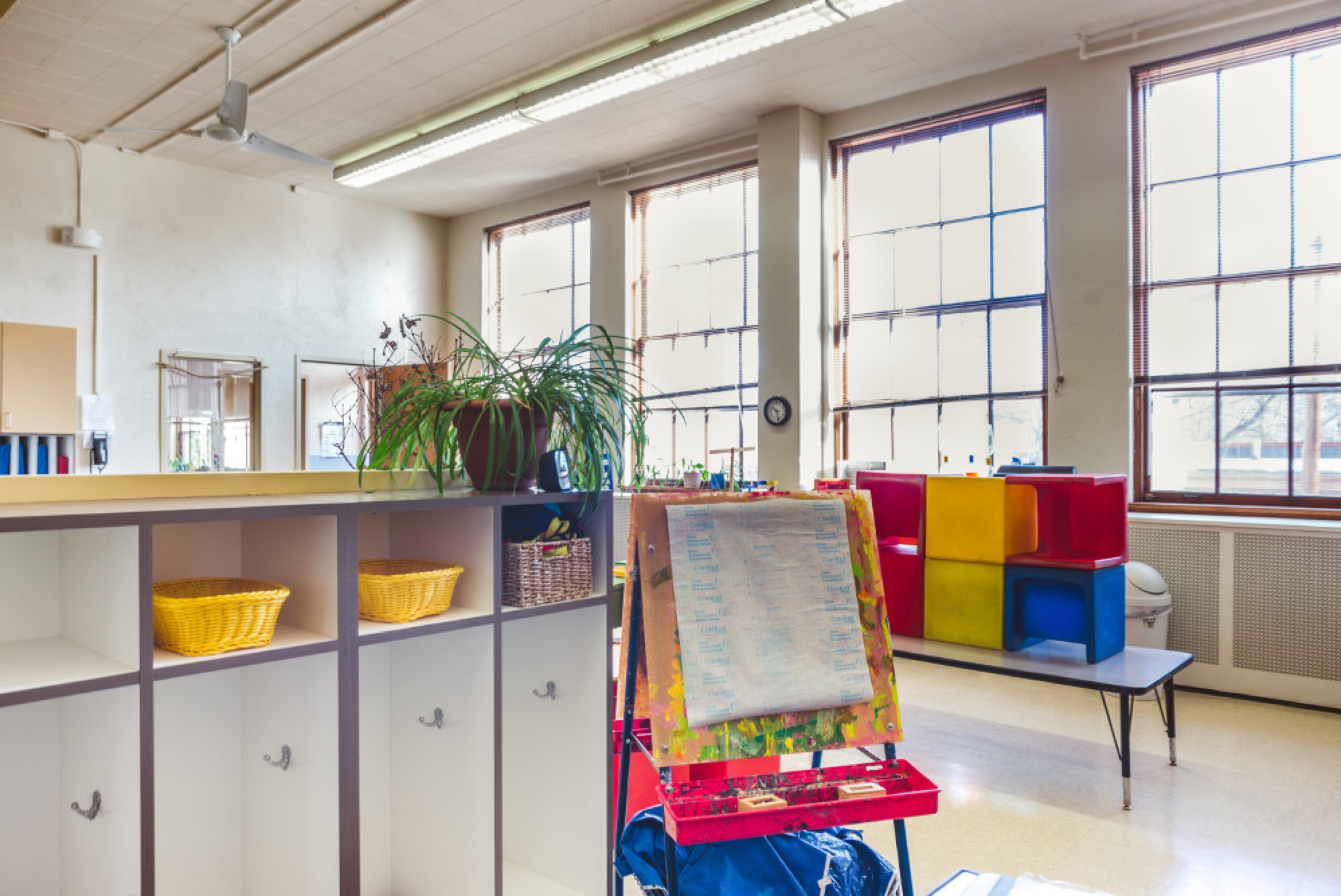 Art-time setup -- easel + cubbies + colorful blocks in natural light