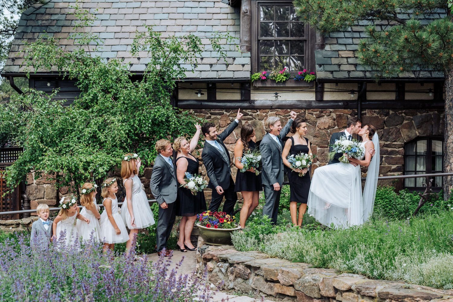 The wedding party outside the stone-and-timber Boettcher Mansion, lavender beds along the path