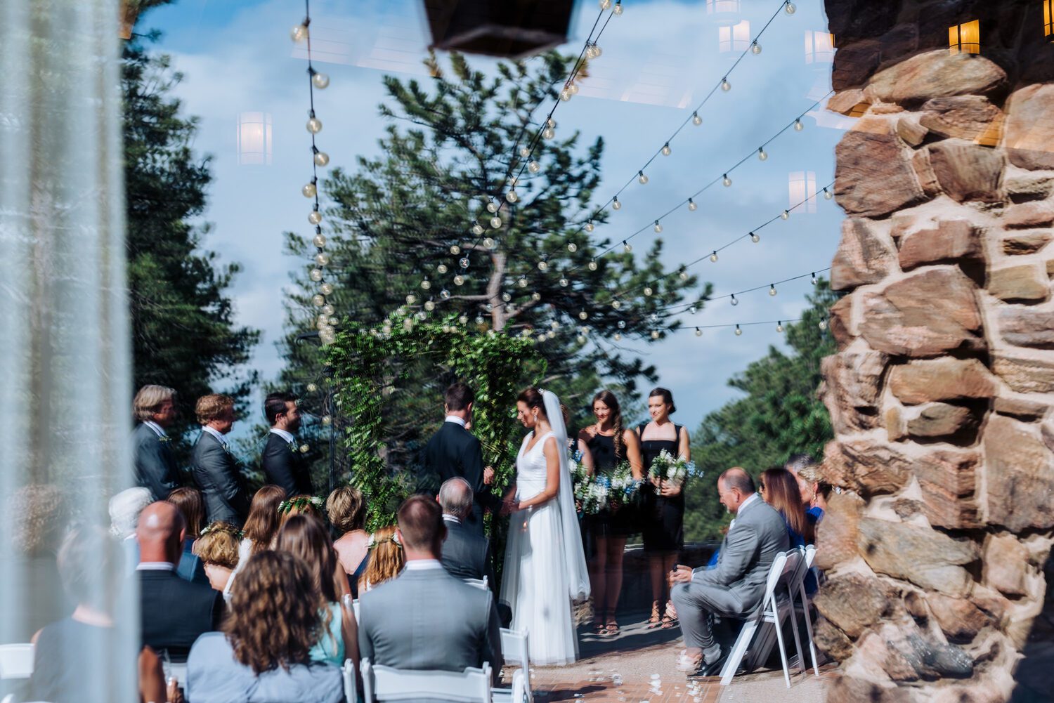 Outdoor ceremony on the patio at Boettcher Mansion under string lights