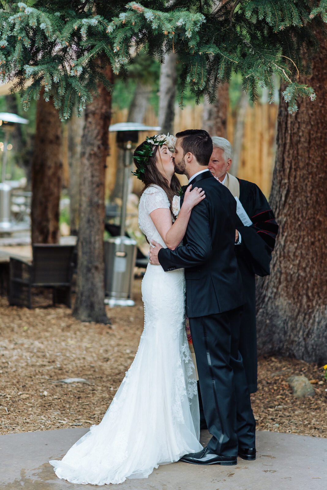 The couple's first kiss with their officiant at Blackstone Rivers Ranch