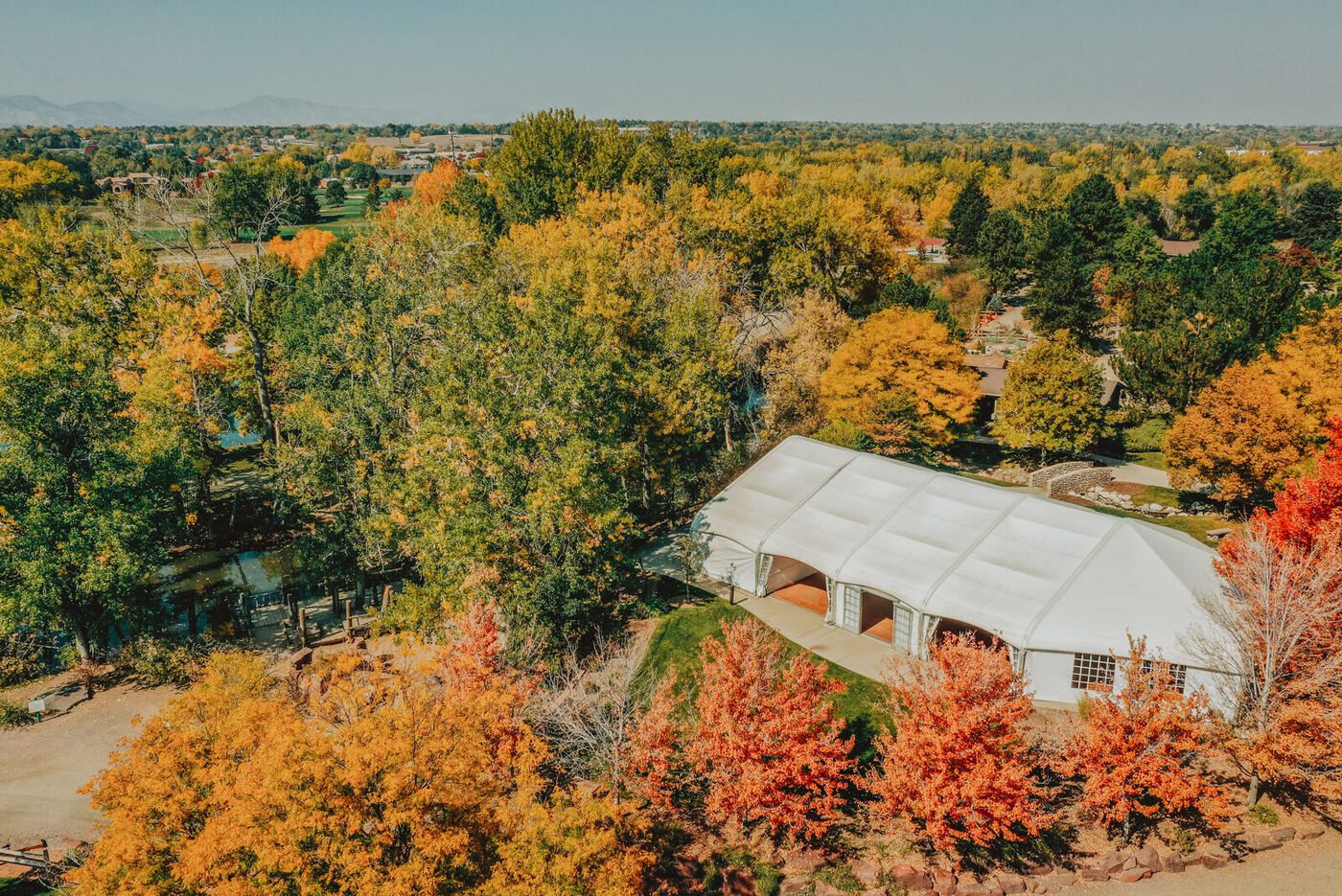Aerial view of the tented event lawn at Chatfield Farms surrounded by autumn colour