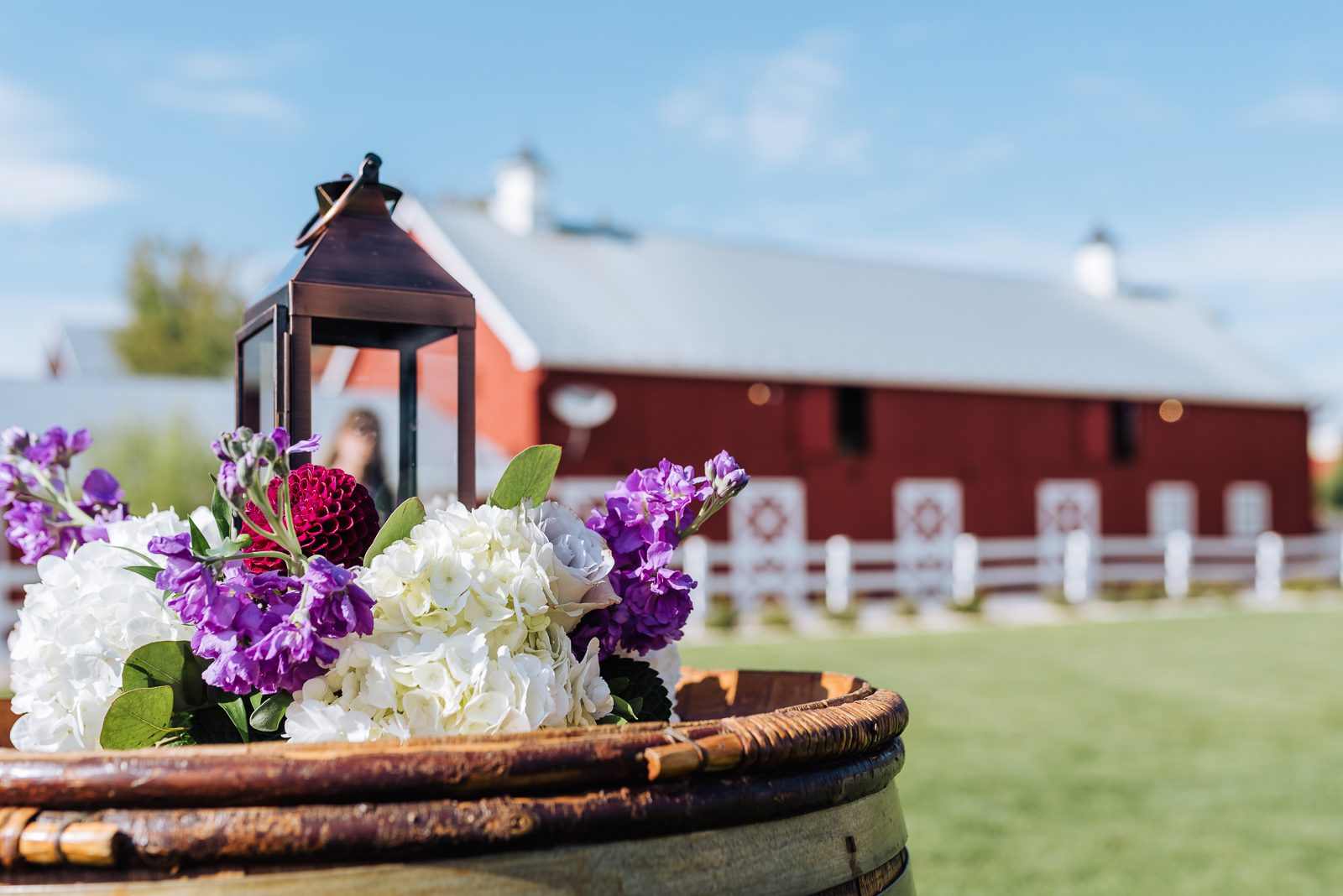 The red barn and white fence at Crooked Willow Farms in Larkspur, Colorado, set for a wedding