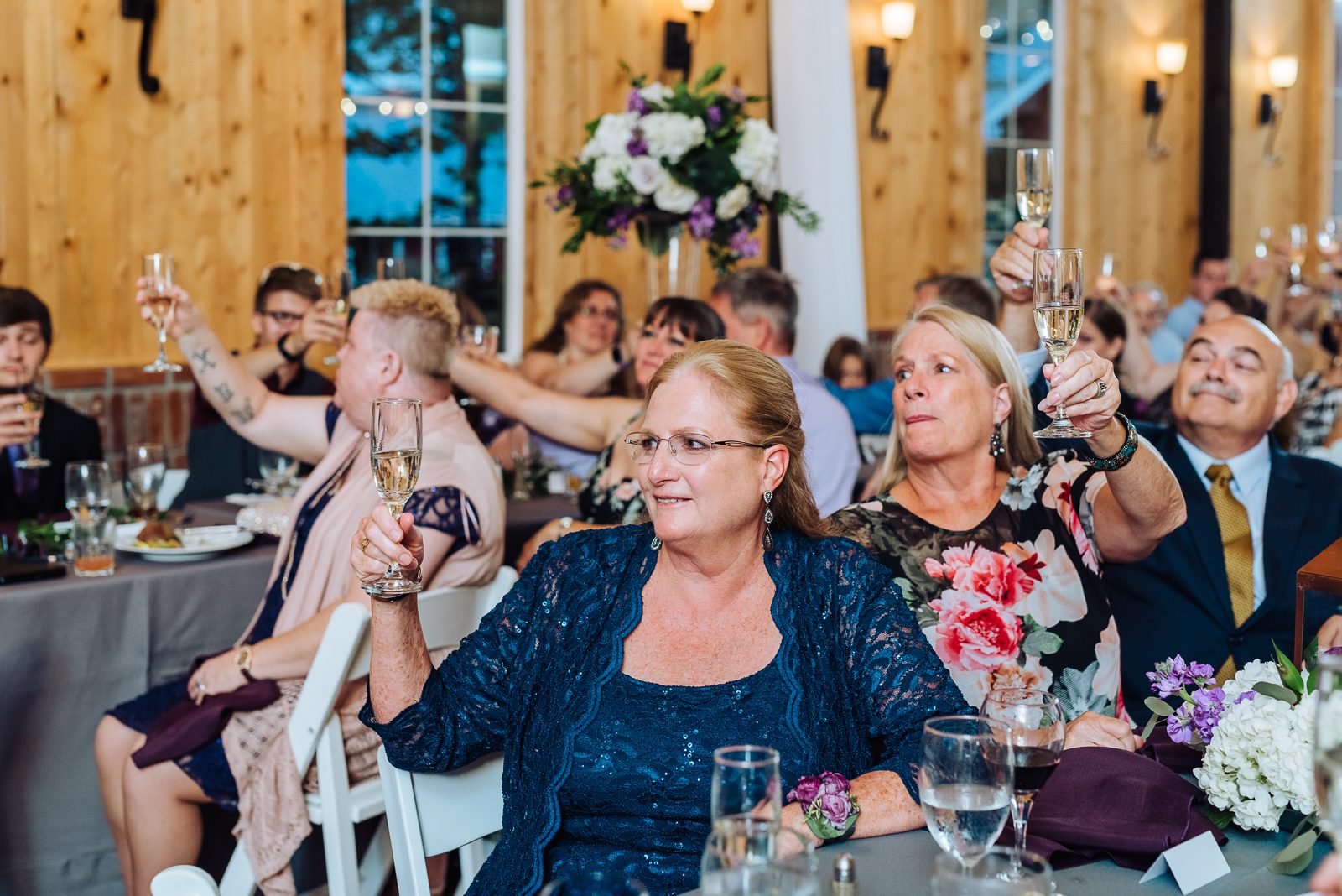 Guests raising a toast at a Crooked Willow Farms wedding reception