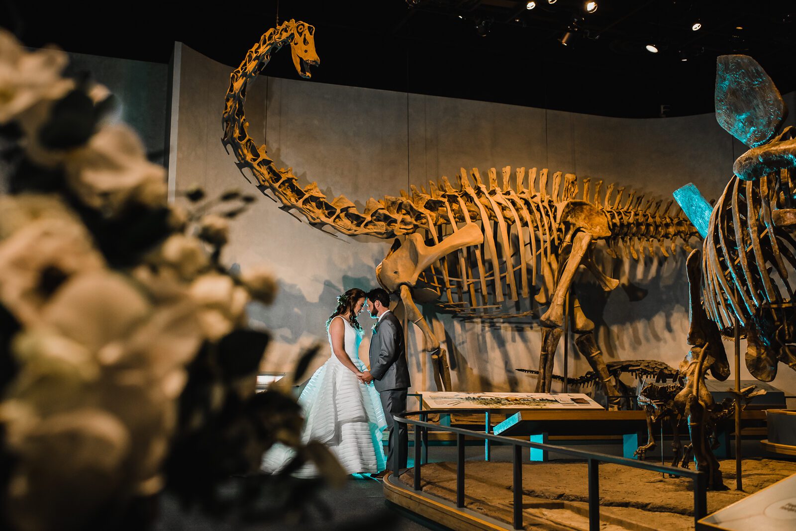 Wedding couple in the dinosaur hall at the Denver Museum of Nature and Science
