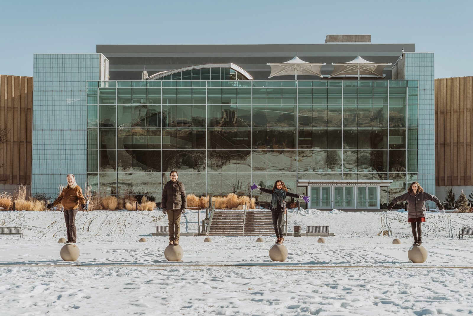 The glass facade of the Denver Museum of Nature and Science seen from the plaza in City Park