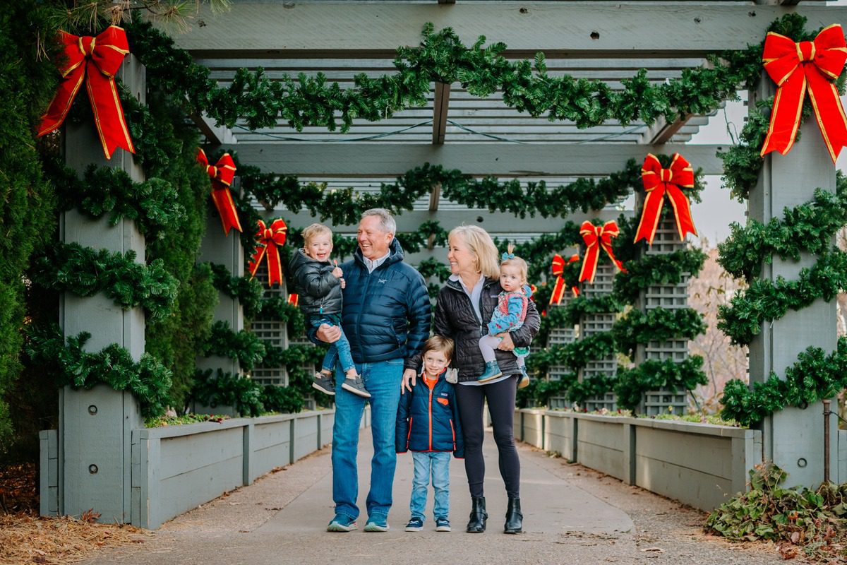 Family portrait under the garland-draped pergola at Denver Botanic Gardens