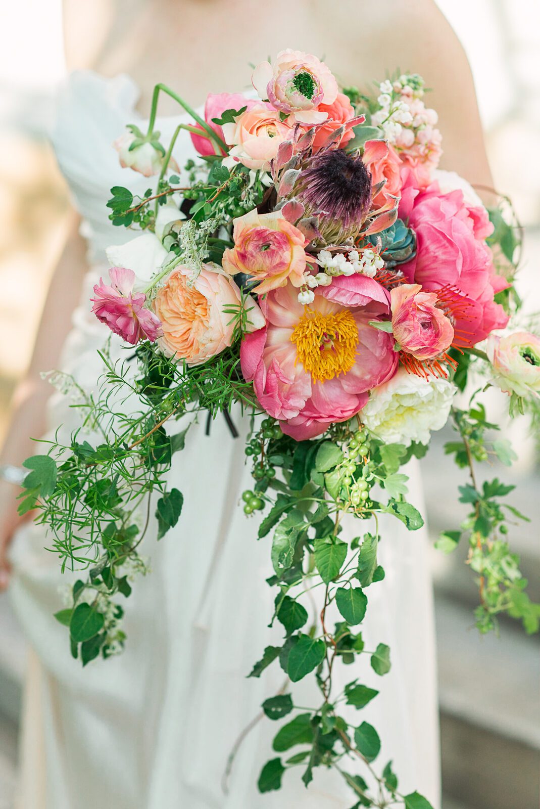 Bridal bouquet of peonies, garden roses and trailing greenery at a Grant-Humphreys Mansion wedding