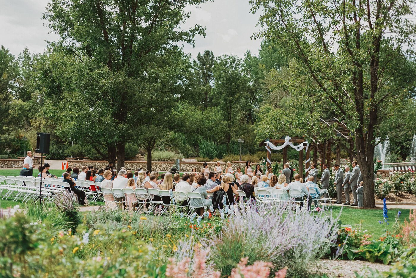 An outdoor wedding ceremony beside the water at Hudson Gardens