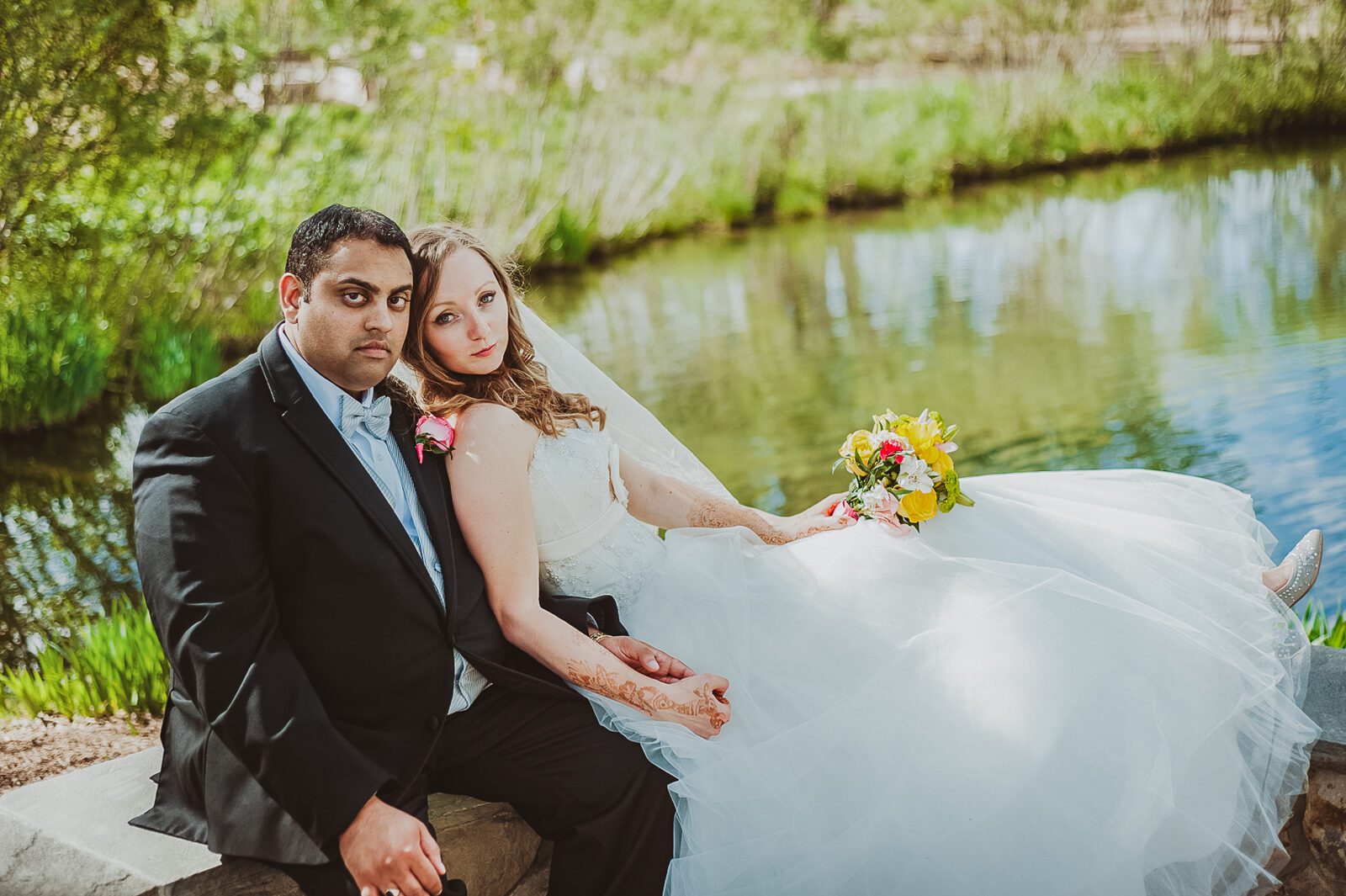 Bride and groom beside the pond at Hudson Gardens