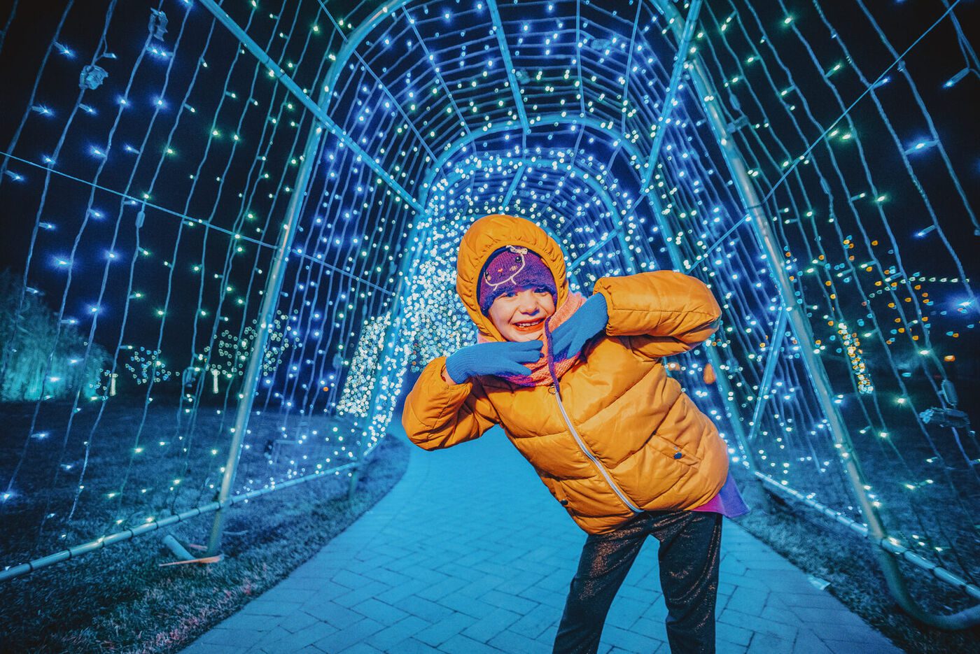 A child inside the light tunnel at the Hudson Gardens winter lights display