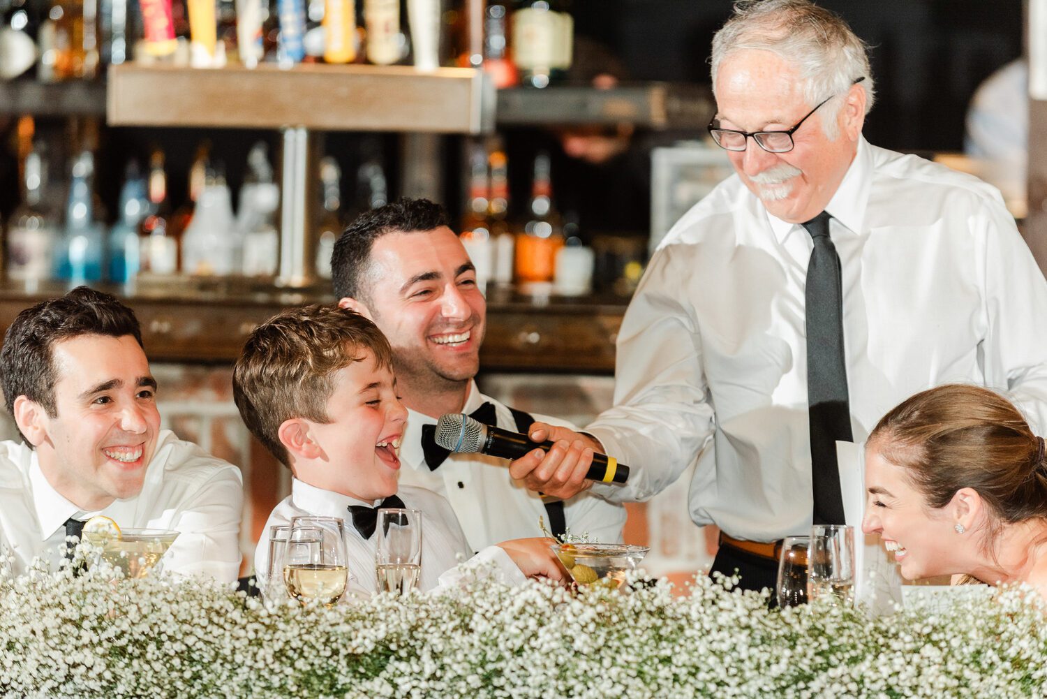 A guest pouring champagne for the head table at a Mile High Station reception
