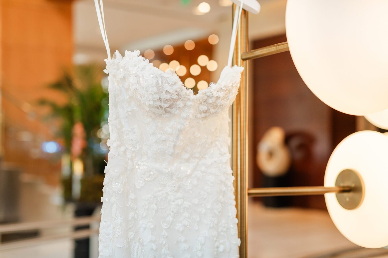 Detail of the beaded bodice of the wedding dress before a Mile High Station wedding