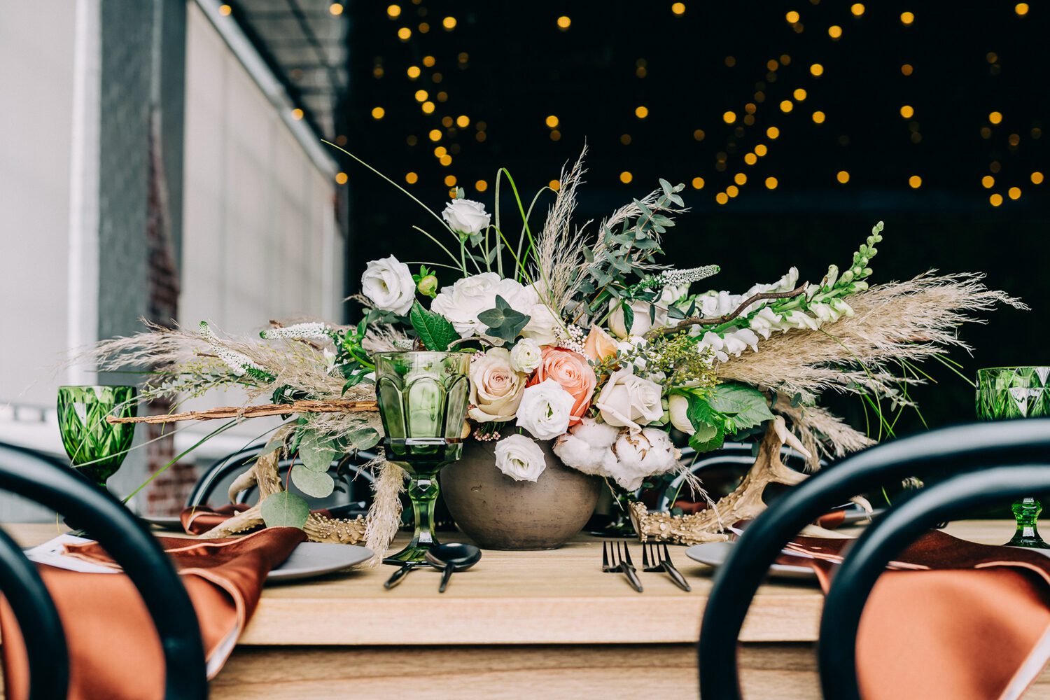 Florals under the string lights at Moss Denver