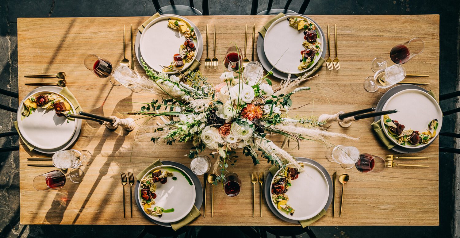 Overhead tablescape with dried florals, gold flatware and slate plates at a Moss Denver wedding