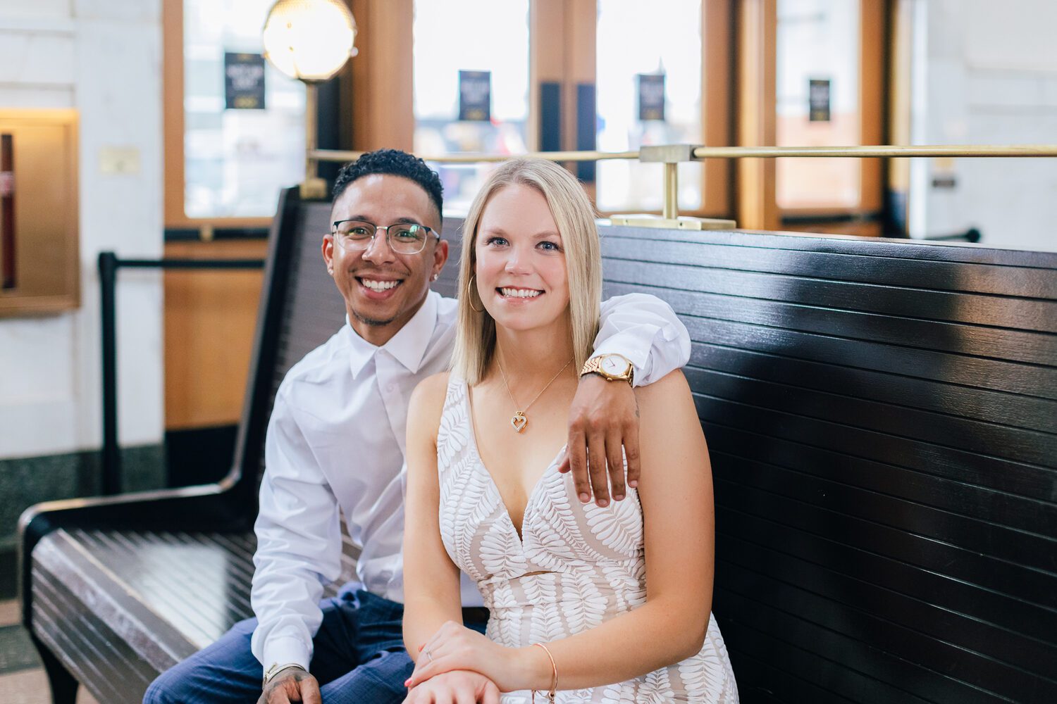 Couple on the historic wooden benches in the Great Hall at Denver Union Station