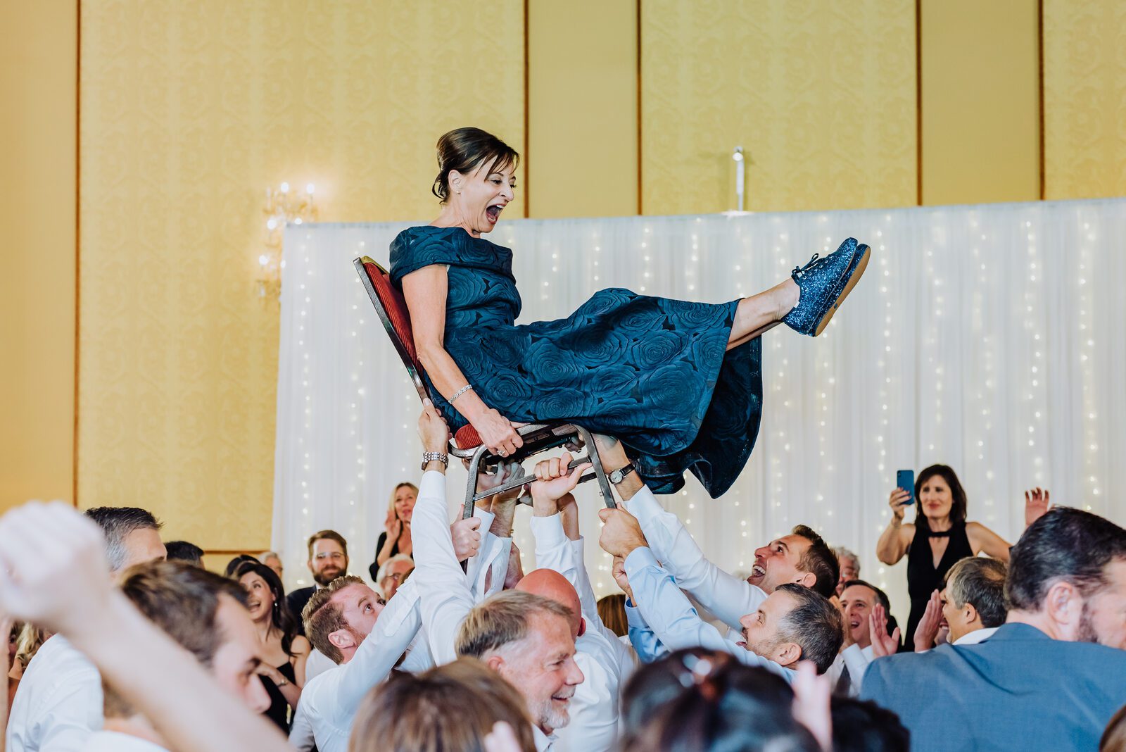 A guest lifted on a chair during the hora at a Denver Athletic Club reception