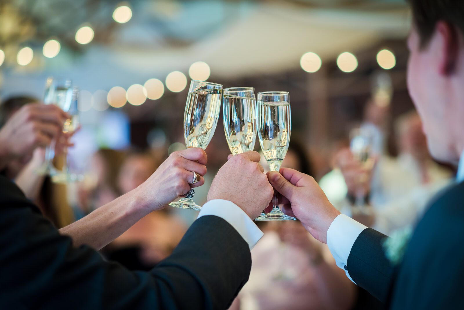 Champagne raised for a toast at a Denver Athletic Club reception